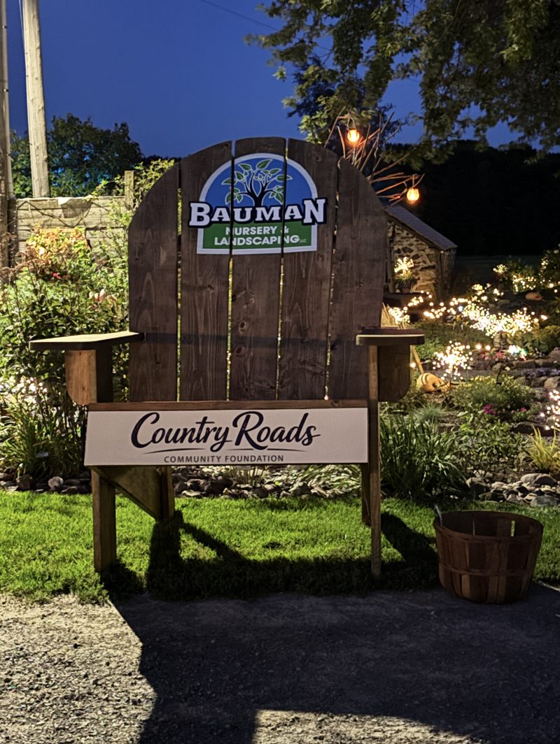 Giant Adirondack chair with Bauman Nursery and Country Roads signs